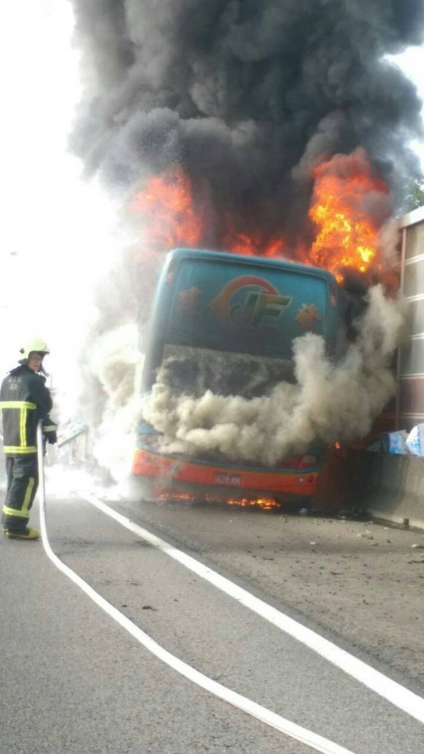 消防員布水線朝遊覽車灌救，試圖撲滅火勢。（記者鄭鴻達翻攝）