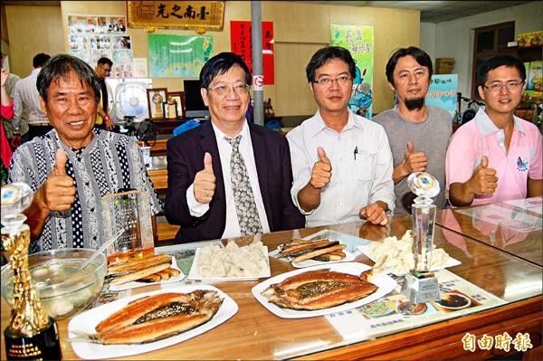 北門長盈海味屋黃碧田（左一）、黃國良（右二）父子的虱目魚乾，獲得今年農委會水產精品「海宴獎」，漁業署副署長黃鴻燕（左二）昨天前往祝賀，行銷虱目魚。（記者楊金城攝）