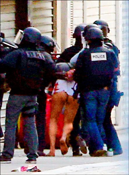 法國警方十八日在巴黎北郊聖丹尼進行大規模圍捕行動，據信目標即為巴黎恐怖攻擊事件主謀、比利時好戰份子阿巴伍德。圍捕行動歷經七個小時，過程中一名女子引爆炸彈自殺，另一名疑似聖戰份子者遭擊斃，共七人被捕。但警方仍無法確定阿巴伍德是否已死或被捕，有待鑑識認定。圖為警方逮捕一名身分不詳的男子。（美聯社）