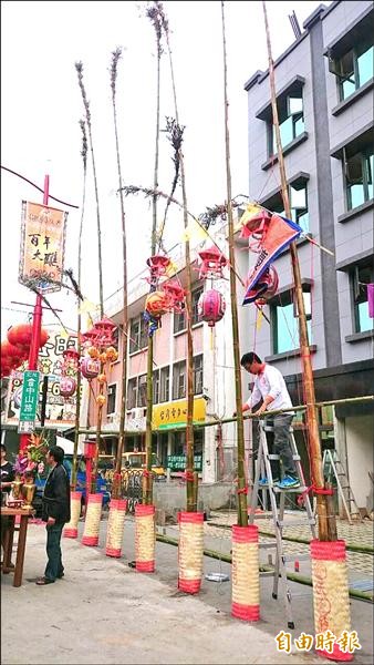 新港鄉奉天宮舉行百年大醮，昨天豎立7支燈篙，為建醮揭開序幕。（記者余雪蘭攝）