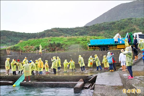 和美國小師生與海大、農業局人員一同放流魚苗。（記者林欣漢攝）