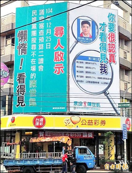 台中第二選區陳世凱陣營前晚換上「你要很認真才看得見我」看板，顏陣營昨天又換上「尋人啟示～懶惰！看得見」反制。（記者陳建志攝）