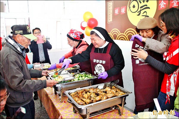 嘉義縣長張花冠（左）、中華聖母基金會董事長陳美惠（中）等為老人家打飯。（記者林宜樟攝）