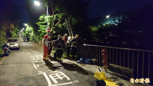 消防人員架設梯子救人。（記者游承霖攝）