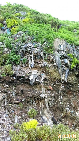 颱風及東北季風致掩埋在潮境公園覆土下的垃圾裸露。（記者林欣漢攝）