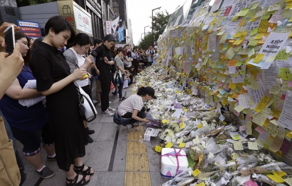 許多民眾到事發地點附近的地鐵站外側，貼紙條、獻化悼念。（資料照，美聯社）