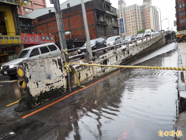 民族路橋旁道路因淹水拉起封鎖線。（記者陳昀攝）