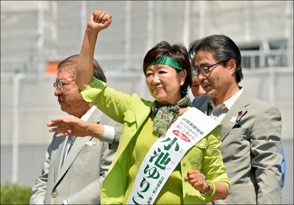 曾任環境大臣、防衛大臣的小池百合子（中）這次自行參選，與最大對手的增田都以綠色做為宣傳的代表色，圖為她於三十日選戰最後一天在東京街頭造勢；而新任都知事將接手二○二○年奧運的籌備工作。（法新社）