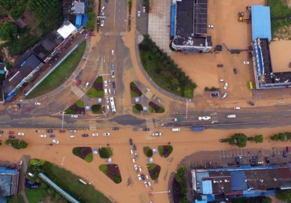 透過當地媒體空拍畫面可以看到，黃色泥水癱瘓了整個市區道路，讓當地交通完全打結。（圖截自中新網） 