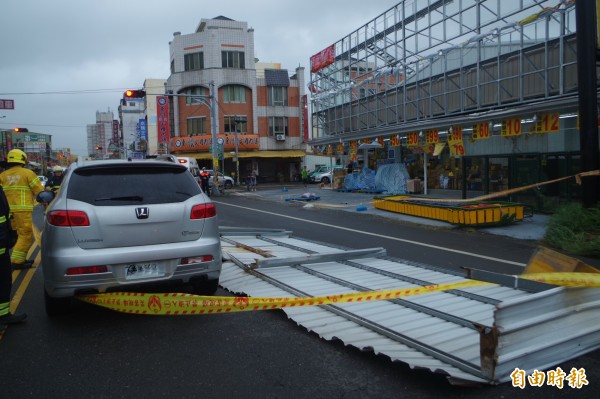 商店招牌掉落，砸中路過休旅車。（記者林國賢攝）