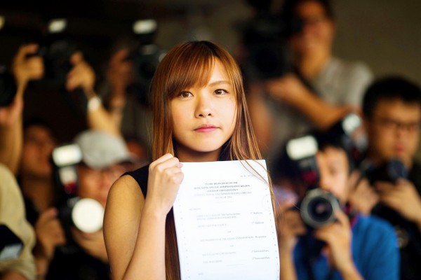 Hong Kong legislator-elect Yau Wai-ching of the Youngspiration party shows the judge’s ruling at a press conference outside the
Photo: EPA