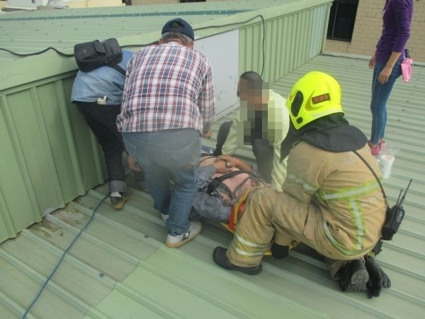 高雄市鳳山區一名工人上午到三樓維修鐵皮屋頂，可能不小心誤觸穿過屋頂上方的高壓電線。（記者蔡清華翻攝）