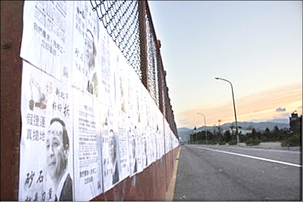 學生社團「國立臺北大學翻牆社」在三峽龍埔路的LB05站施工圍籬上，貼滿印有「炒地市長朱立倫」的抗議傳單。（北大翻牆社提供）