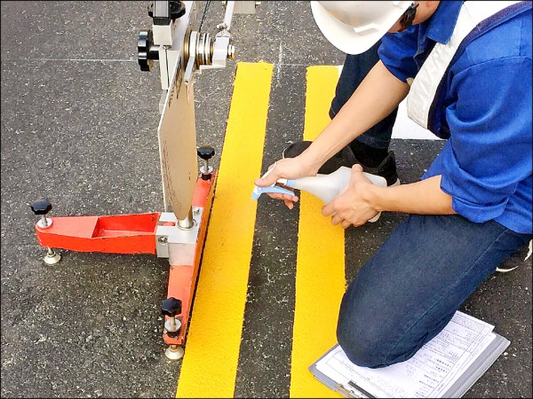 建設局施工提升道路標線抗滑能力，讓行車更安全。（建設局提供）