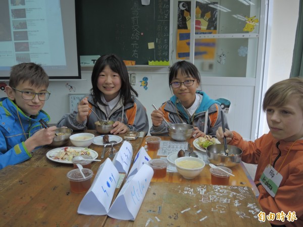 兩位波蘭小男生首次拿筷子品嚐茶餐很開心。（記者翁聿煌攝）