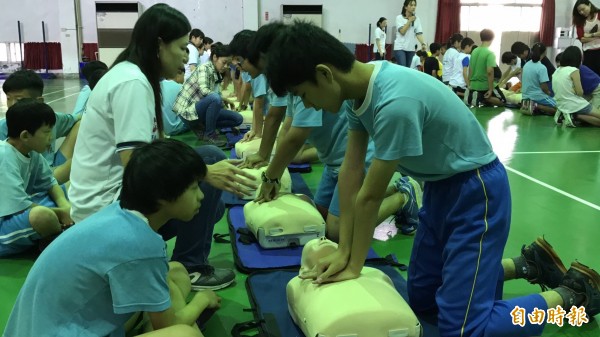 花壇國小203名應屆畢業生今天參加CPR測驗，對「安妮」按壓胸脯，有模有樣。（記者湯世名攝）