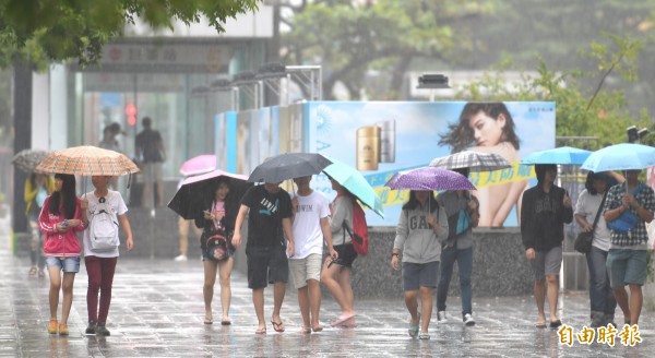 滯留鋒面及西南氣流影響。高雄市區從清晨開始降雨，至中午雨勢時大時小。（記者黃志源攝）