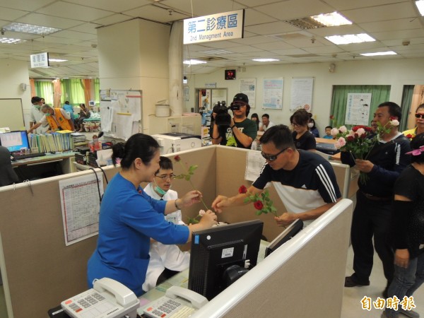 苗栗市的里長及鄉親到醫院內送花，替醫護人員加油打氣。（記者張勳騰攝）