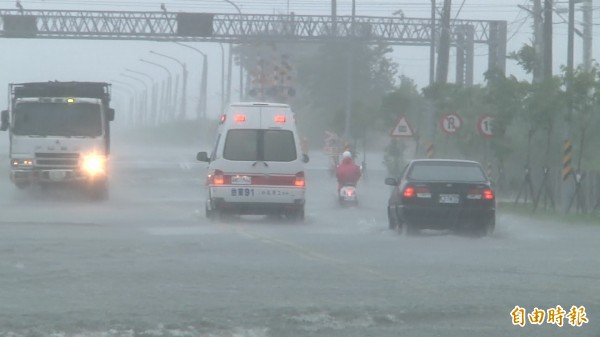 超大豪雨造成台東大學前方平交道前馬路淹水，兩名騎機車東大生被沖倒受傷。（記者陳賢義攝）