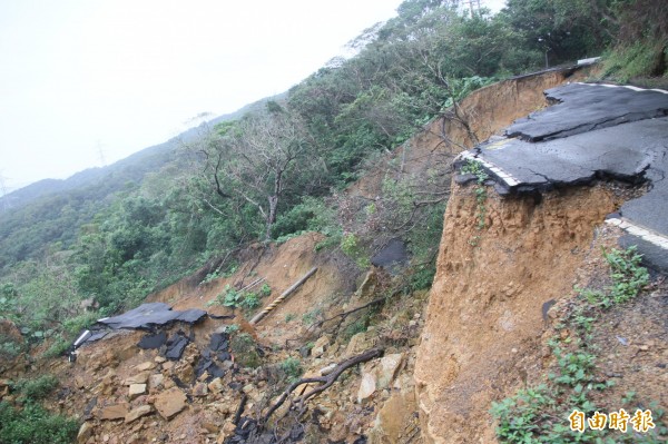 基隆市連接中山區與情人湖、大武崙砲台的德安產業道路，今年6月因大雨道路坍塌，高低落差達13多公尺，人車無法通行。（記者林欣漢攝）