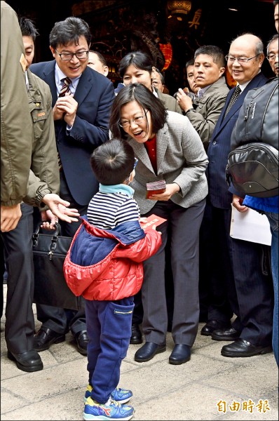 總統蔡英文、民進黨立委姚文智17日至台北保安宮發送紅包，向民眾拜年。（記者羅沛德攝）