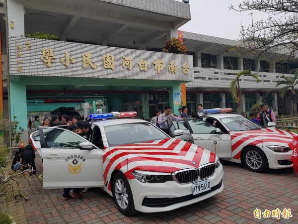 國道警第八大隊今日前往白河國小宣導交通安全、反毒，兩輛紅斑馬停在校園，學童好奇觀看、試乘。（記者王涵平攝）