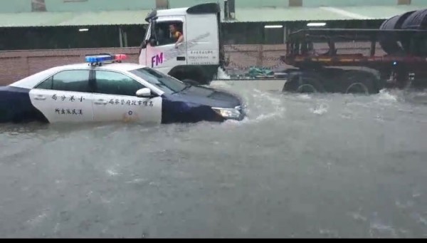 警車救災也陷入大水中，民眾驚呼：「水陸兩棲警車？」（記者洪臣宏翻攝）