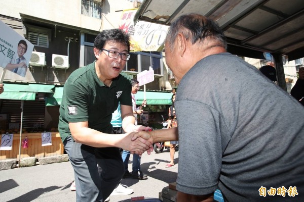 民進黨台北市長參選人姚文智北投金龍市場拜票，稍後又接受廣播節目專訪。（記者蔡亞樺攝）