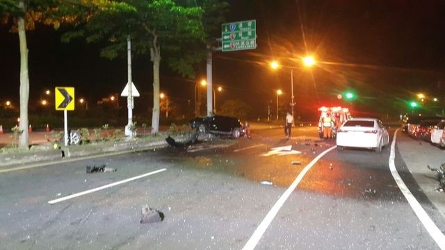 黑色轎車撞上中央分隔島，慘成一具廢鐵，車上兩名少年重傷送醫。（記者鄭名翔翻攝）