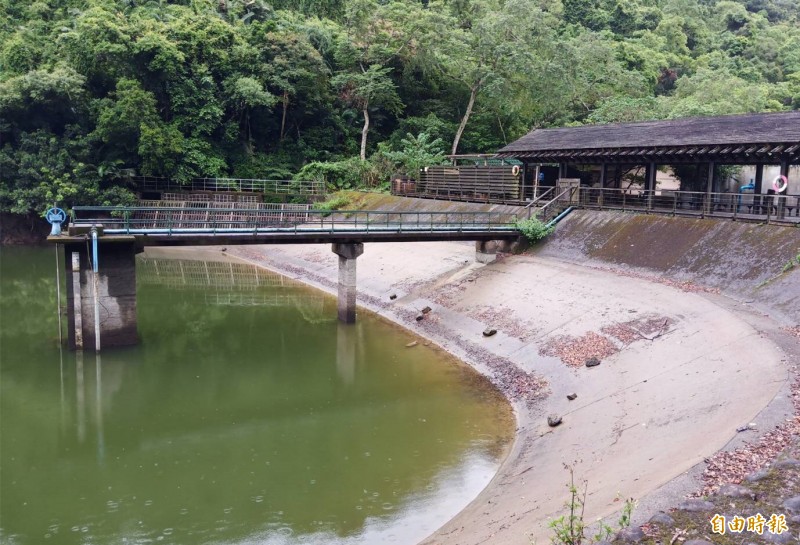 大溪後慈湖疑因水利設施損壞，水位持續下降，池邊岩石已裸露一大截。（記者李容萍攝）