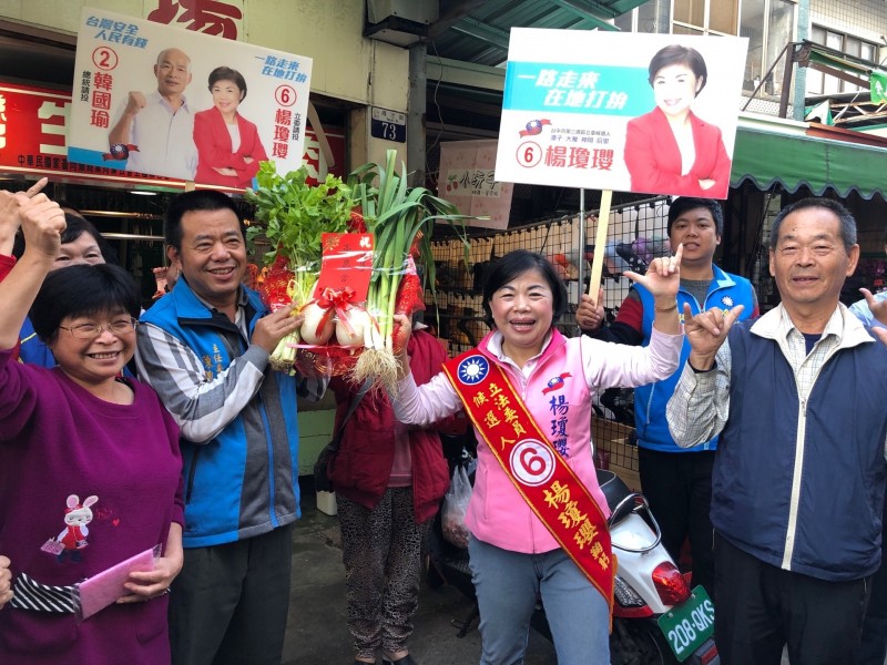 立委候選人楊瓊瓔到市場拜票，攤商等紛送上菜頭及青蒜等，祝「好采頭」、「凍蒜」。（楊瓊瓔團隊提供）