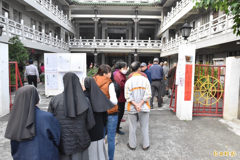 天氣晴朗舒適一早雲林斗南祥雲寺投票所排隊等待投票人大排長龍。（記者黃淑莉攝）