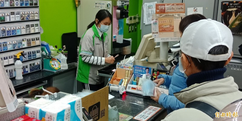 全家彰化新彰基店今天傍晚口罩配送到店，還來不及上架，就已吸引不少民眾搶購。（記者張聰秋攝）