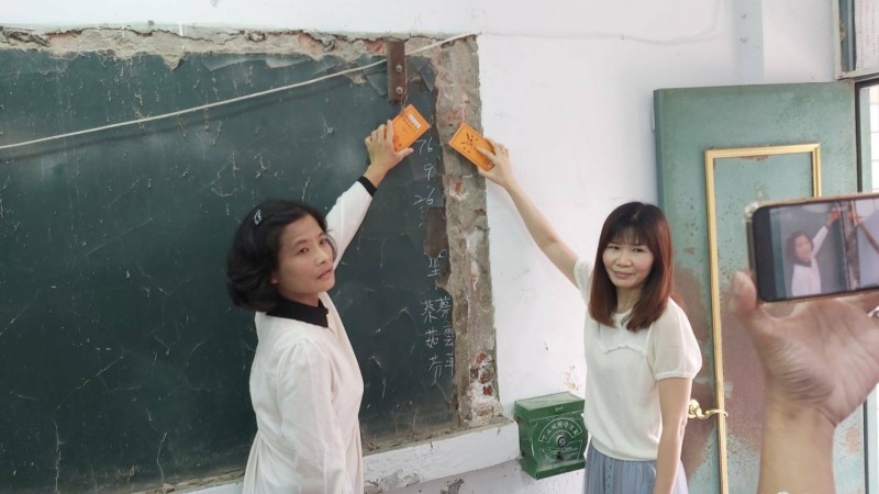 南寧高中33年前值日生蔡雲萍和蔡茹芬，今天上午返校「擦黑板」完成當年任務。（記者王姝琇翻攝）