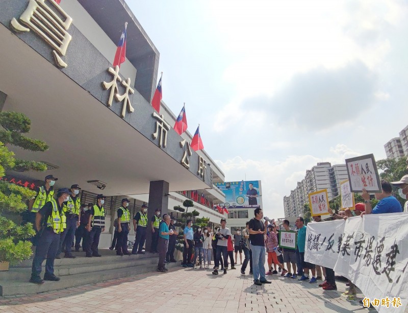 員林果菜市場盤商不滿重建案未經討論，要求搬遷墓地旁，近300位盤商舉白布條到員林市公所抗議。（記者陳冠備攝）