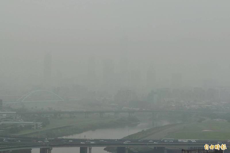 空氣品質不佳，環保署空氣品質監測顯示，今日（25日）西部各測站亮紅燈警示，台北101大樓下午快看不見了。（記者鹿俊為攝）