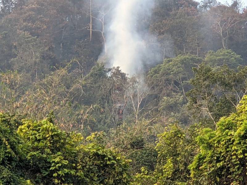 南投魚池國中後方山坡發生山林火警，經陸空灌救，校園後方火勢已獲控制，惟延燒部分仍還有火煙與明火。（記者劉濱銓翻攝）