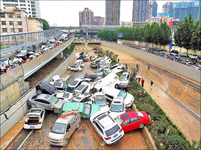 中國河南省水患仍在持續，省會鄭州「京廣快速道路隧道」災情慘重。圖為廿二日隧道出口車輛堆疊慘況。（法新社）