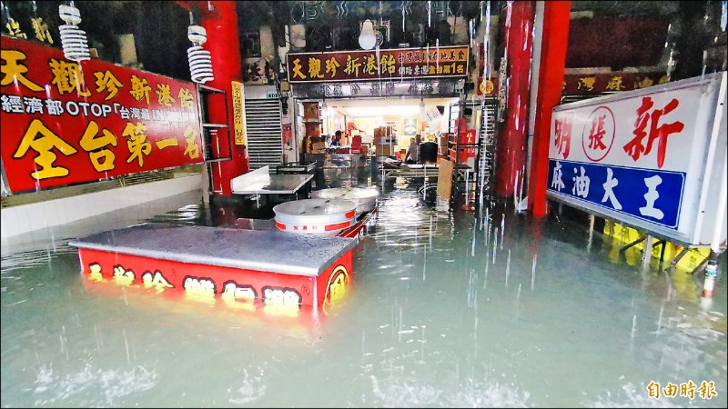 嘉縣新港奉天宮前道路宛如河道，水漫進兩旁店家。（記者蔡宗勳攝）