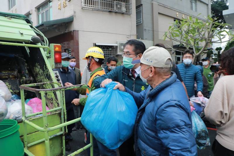 台南市長黃偉哲幫忙老家人倒垃圾包。（台南市府提供）