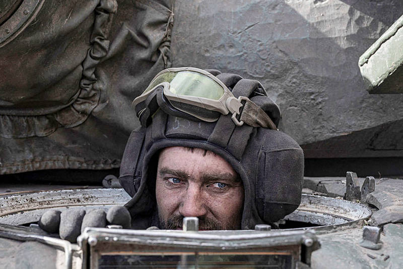 
A Ukrainian serviceman sits inside a captured Russian tank in Lukyanivka, Ukraine, on Sunday.
Photo: Reuters