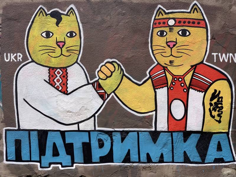 乌克兰南部城市敖德萨（Odesa）街头，出现穿戴乌克兰、台湾2国传统服饰的拟人猫咪，双方相互握手、以示友好的街头涂鸦。（图翻摄自推特）(photo:LTN)