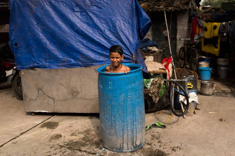 印度天氣太炎熱，一名男童泡在水桶中降溫。（法新社）