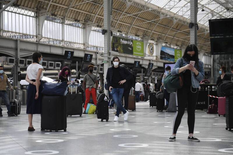 2020年疫情初爆發時，巴黎火車站民眾戴上口罩。（歐新社）