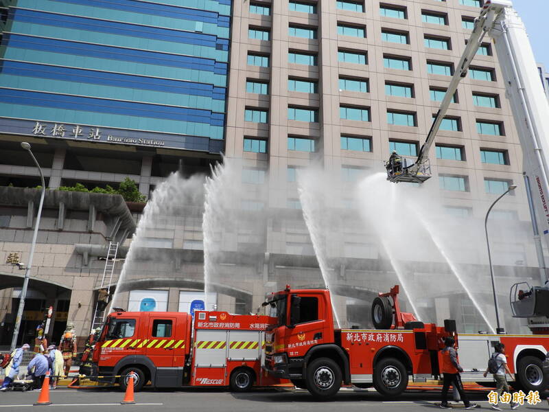 新北市萬安演習模擬板橋車站遭到空襲，大樓多處起火，消防員撲滅火勢。（記者賴筱桐攝）