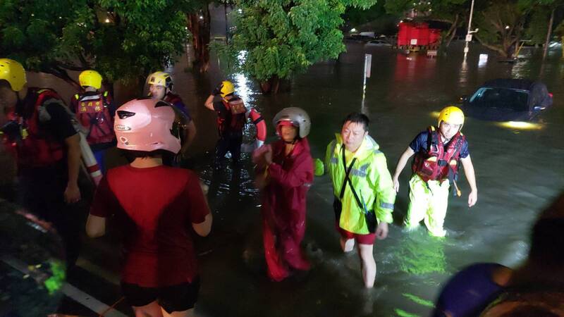 颱風尼莎來襲豪雨成災，有名男子受困士林一處籃球場，他抱著籃球架差點滅頂，消防員獲報後下水順利將他救出。（記者王冠仁翻攝）