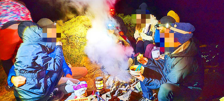 
Hikers sit around what appears to be a campfire on the East Peak of Hehuanshan on Saturday.
Photo courtesy of a member of the public