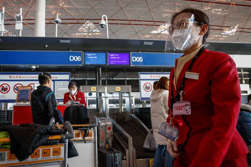 11月30日，中国北京首都国际机场，可以看到航空公司的工作人员在值勤时戴着扣照与护目镜。（欧新社）(photo:LTN)