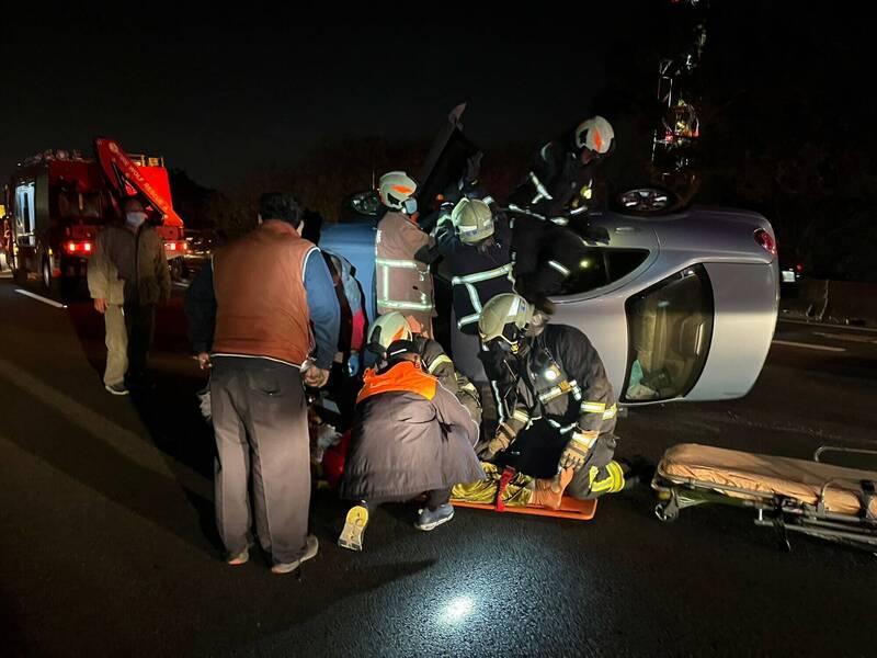 國道1號彰化段今晚發生2輛轎車追撞，其中1輛翻覆，1名女駕駛受困車內，消防員破壞車體搶救。 （消防局提供）