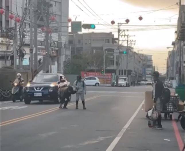 台中市上楓國小棒球隊員分工牽年邁老婦過馬路畫面，讓無數網友感動不已。（擷取自影片）